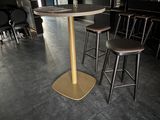 a small table with four stools in a room