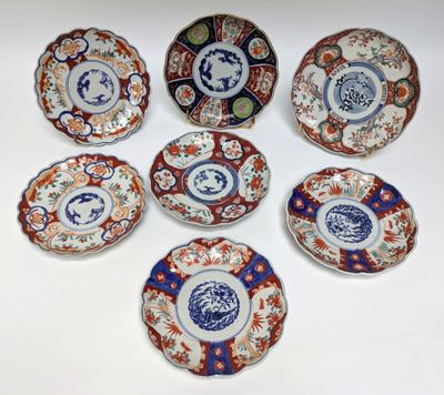 six plates with different designs on them sitting on a white surface