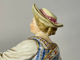 a figurine of a woman with a hat on