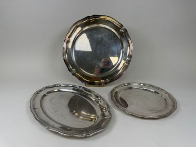 two silver plated dishes and a mirror on a white surface