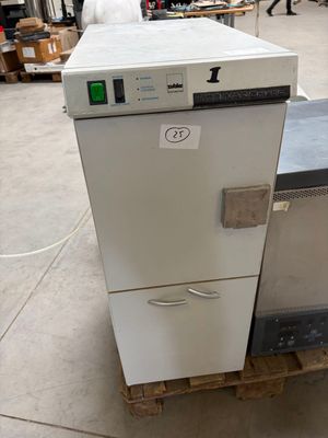 a white refrigerator sitting on top of a pallet in a warehouse