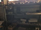 a room with a shelf full of tools and a window