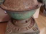 an old coffee grinder sitting on a wooden table