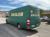 a green van that is parked in a parking lot