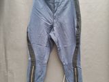des pantalons en jean avec des fermetures éclair, suspendus à une corde à linge sur un cintre