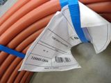 a close up of a bunch of orange hoses on a table