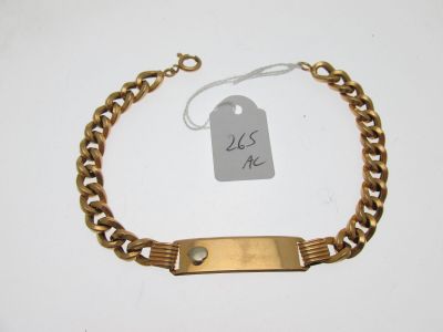 a close up of a gold bracelet with a tag on it