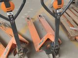 two orange pallets sitting next to each other in a warehouse
