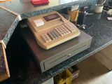 a cash register sitting on a counter in a restaurant
