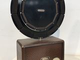an old radio sitting on top of a table next to a white wall