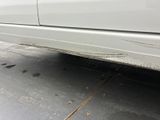 a white car that is parked on the side of the road