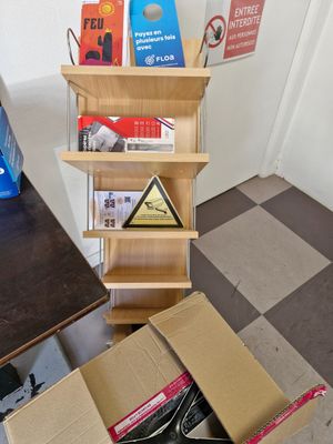 a cardboard box that is sitting on the floor next to a book shelf