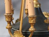 a black and gold chandelier with candles on it