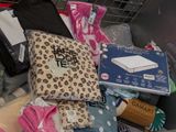 a shopping cart full of clothes and other items