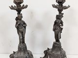 pair of antique bronze candlesticks with figures on pedestals