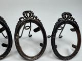 three antique style mirrors are sitting on a white surface