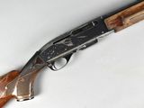 a close up of a rifle with a wooden handle on a white surface