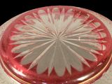 a red glass box with a white flower on it