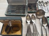 a lot of spoons and spoons sitting on a table