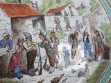 a plate with a picture of a village scene on it