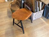 a chair that is sitting in front of a stack of books