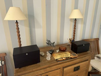 two lamps on top of a dresser in a room