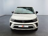 the front view of a white car parked in a room