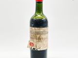 une vieille bouteille de vin rouge avec une étiquette dessus