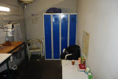 a blue locker in the corner of a small room