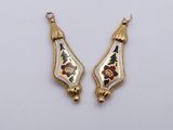 two gold and enamel earrings with floral designs on them