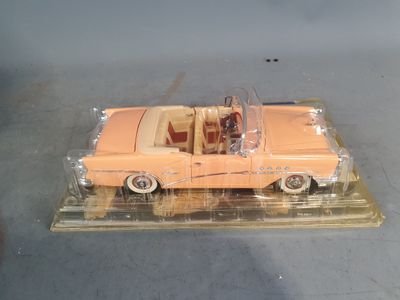a plastic model of a pink car on display