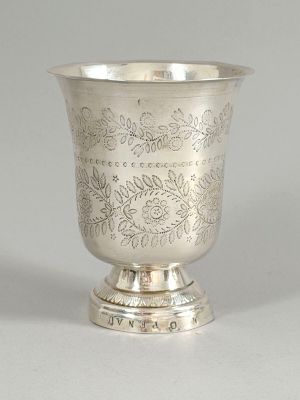 a silver cup that is sitting on a table