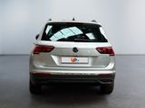 the rear end of a silver volkswagen suv parked in a room