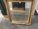 a mirror sitting on the floor next to a door
