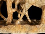 a statue of a horse and a baby horse on a rock