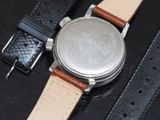 a close up of a watch on a black surface