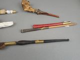 a lot of different types of smoking pipes on the table