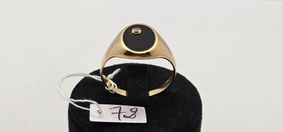 l'image d'une bague en or ornée d'une pierre noire