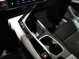 the interior of a car with a touch panel and a steering wheel