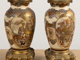 pair of asian vases on stand on table with white background