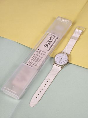 a watch sitting on top of a yellow and blue table