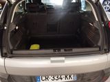 the back of a car with its trunk open in a parking lot