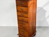 a wooden chest of drawers with four drawers on each side