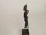 a small bronze statue of a man with a hat on his head