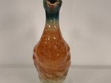 a small vase that has a bird on it