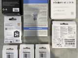four boxes of electronic gadgets sitting on a table