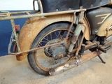 a old motorcycle that is parked in a garage