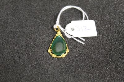 Gros plan sur un collier orné d'une pierre verte