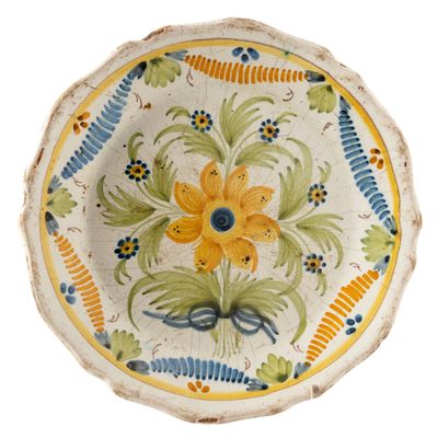 a decorative plate with a yellow flower on it