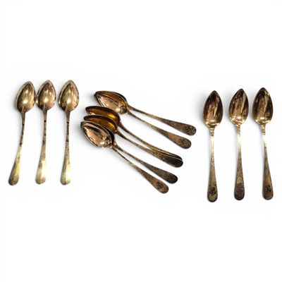 several spoons and spoon spoons are lined up on a white surface